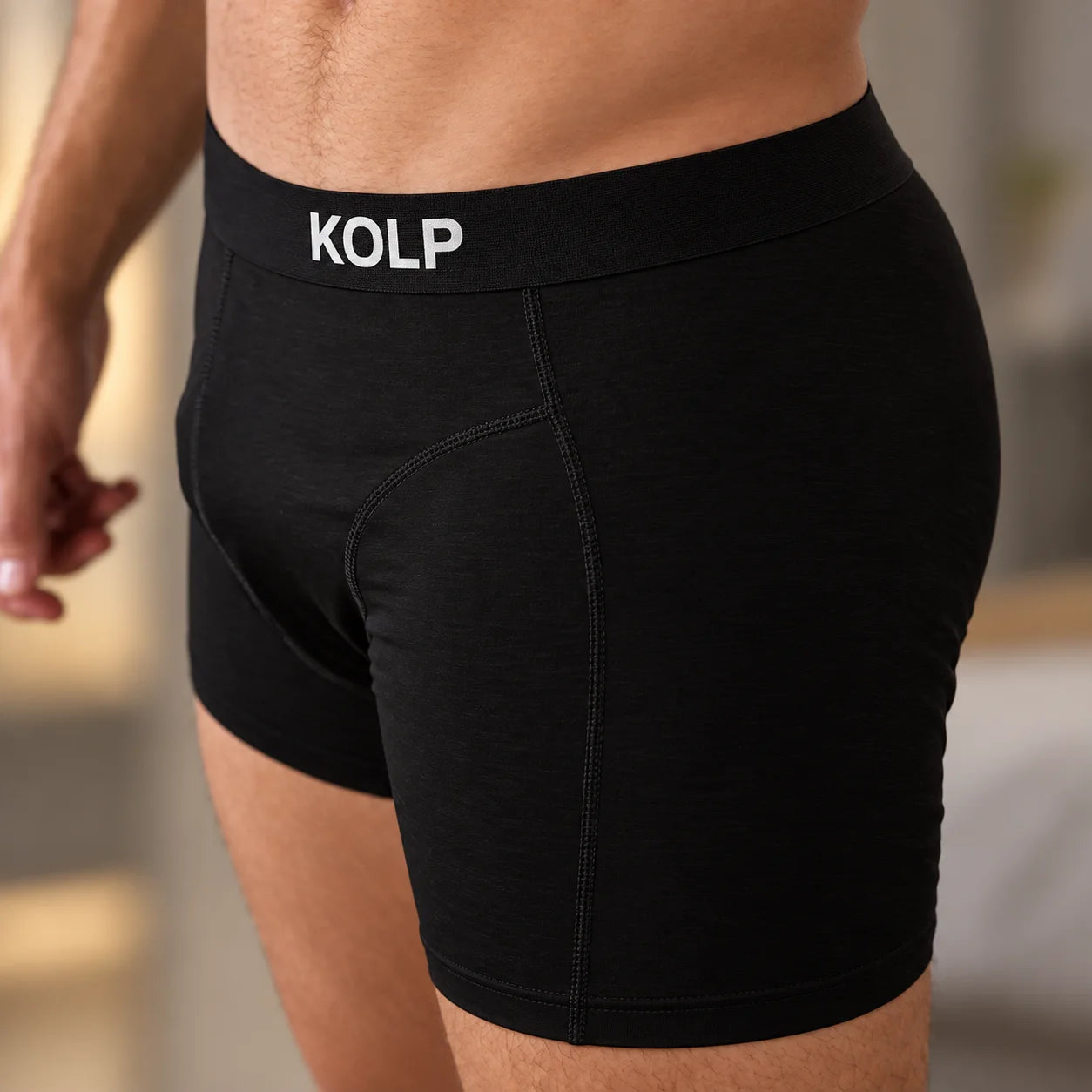 Close-up of the KOLP woven waistband on black boxer briefs
